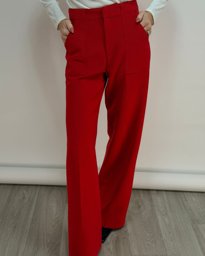 Red pants worn by a person on a plain background