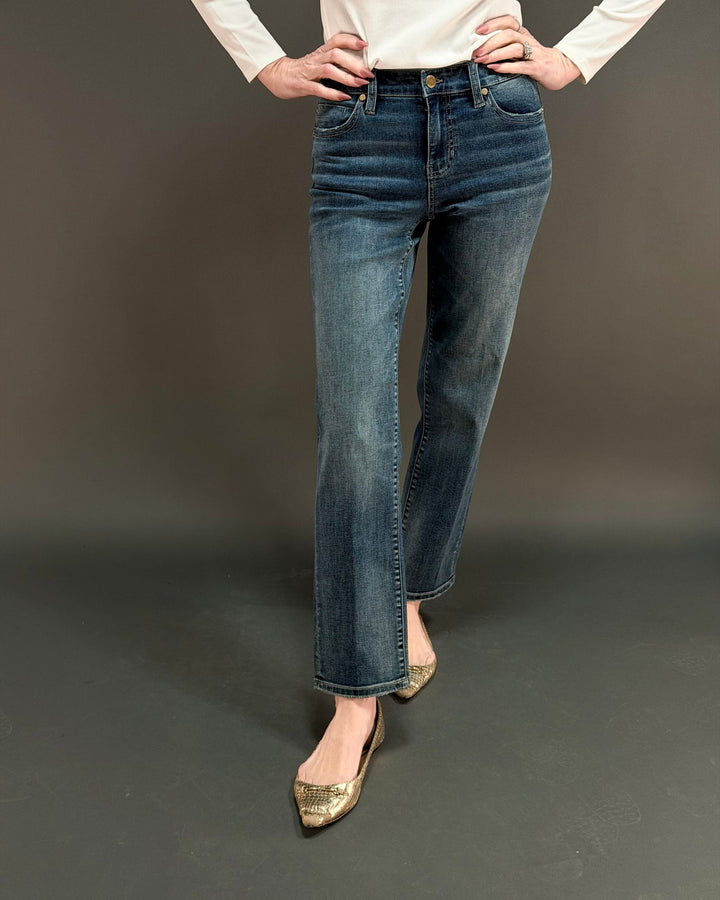 woman wearing straight leg jean in front of a gray background